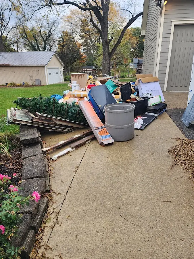 Dumpster being loaded with debris for Residential Dumpster Rental in Smithton